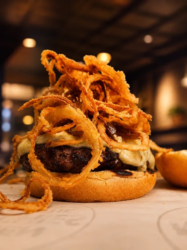Bergen Munchies burger topped with crispy onion rings